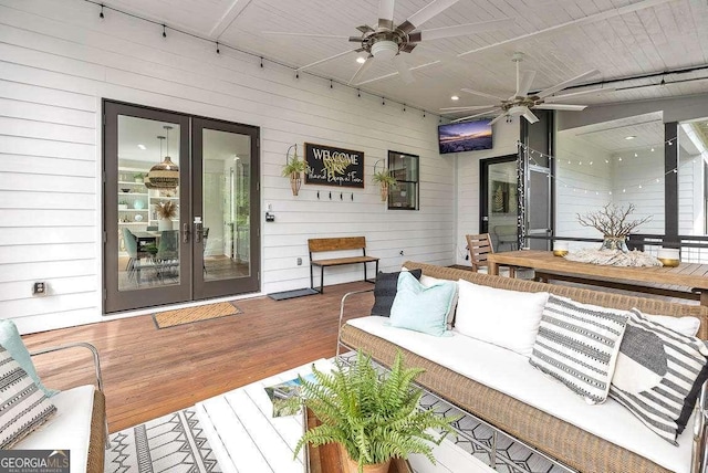 wooden deck featuring french doors, ceiling fan, and outdoor lounge area