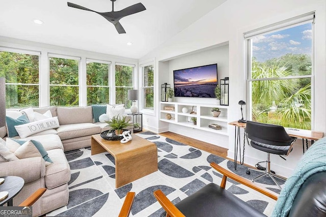 sunroom featuring lofted ceiling and ceiling fan