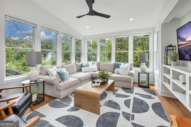 sunroom with lofted ceiling and a ceiling fan