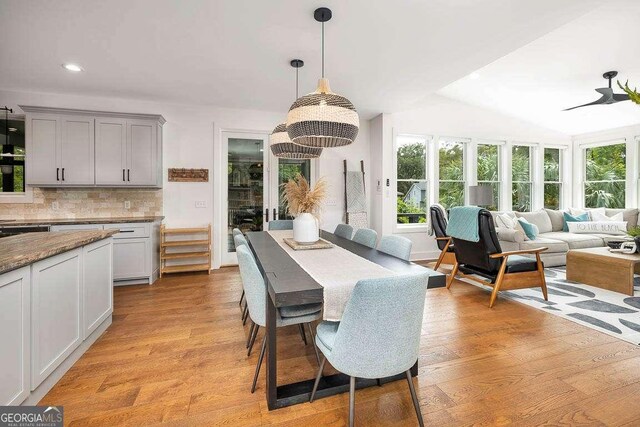 dining space featuring light wood-style floors, recessed lighting, and a notable chandelier