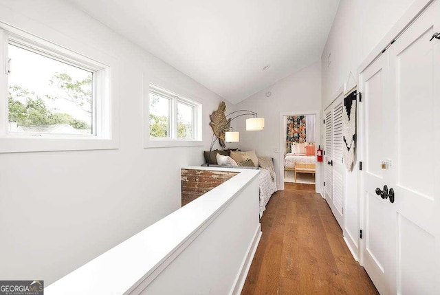 bedroom featuring lofted ceiling and wood finished floors