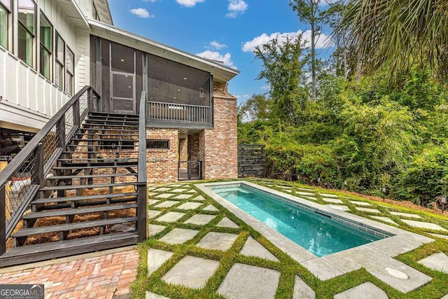 view of swimming pool featuring a sunroom