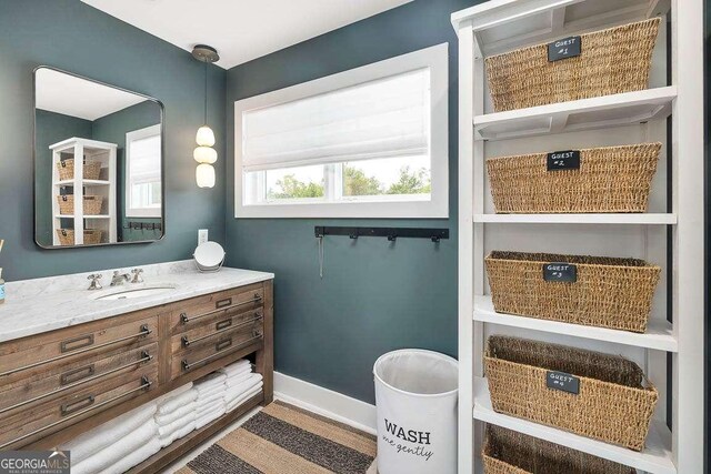 bathroom with vanity and baseboards