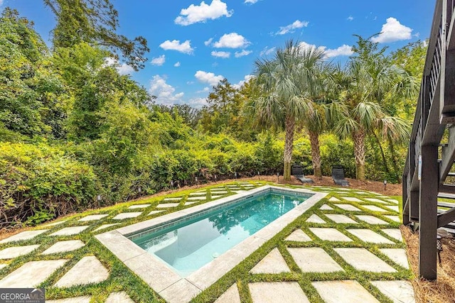 view of pool featuring a yard