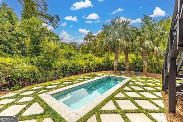 outdoor pool with a patio area