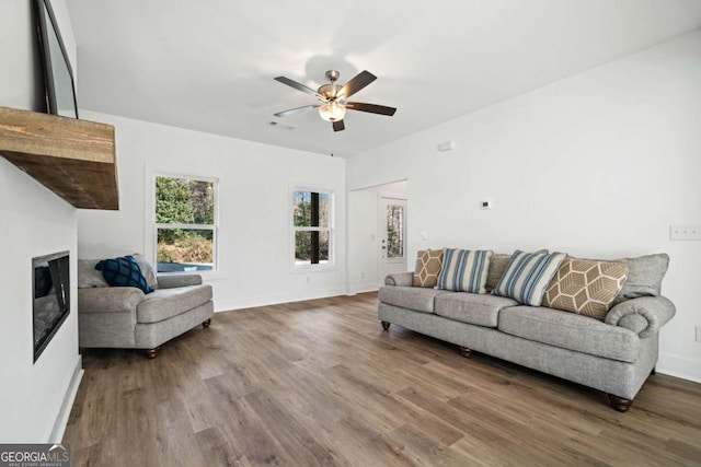 living room featuring ceiling fan and hardwood / wood-style floors