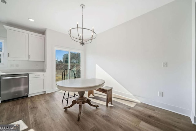 dining area featuring an inviting chandelier and dark hardwood / wood-style floors