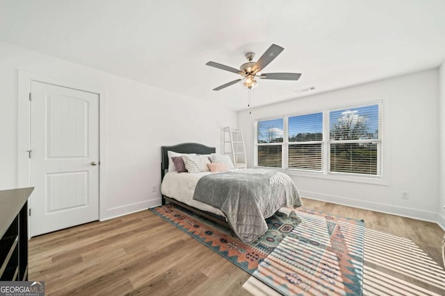 bedroom with ceiling fan and light wood-type flooring