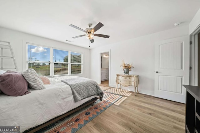 bedroom with ensuite bathroom, ceiling fan, and light hardwood / wood-style floors