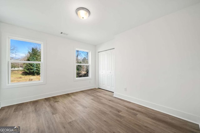 spare room with light wood-type flooring