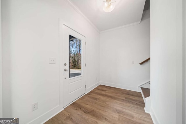 foyer entrance featuring ornamental molding and light hardwood / wood-style floors