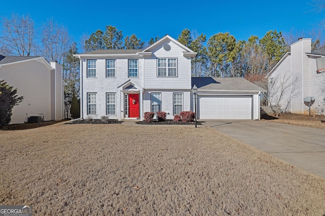 view of front of home featuring a garage, a front yard, and cooling unit