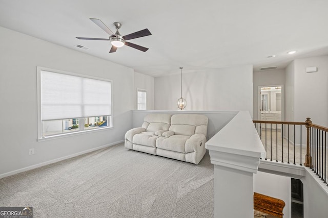 living room featuring ceiling fan and carpet flooring