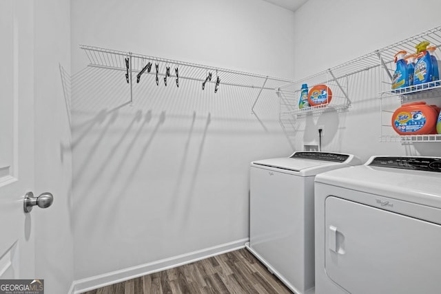 washroom with washer and dryer and dark wood-type flooring