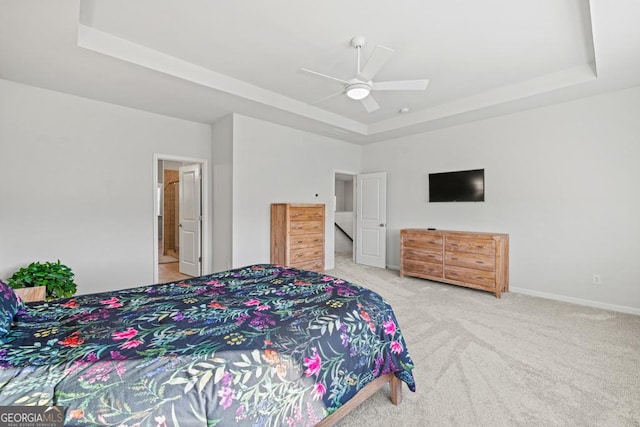 bedroom with ceiling fan, a raised ceiling, and carpet