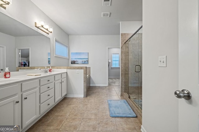 bathroom with vanity, tile patterned floors, and a shower with shower door