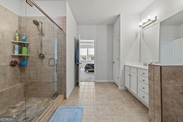 bathroom featuring tile patterned flooring, vanity, and a shower with shower door