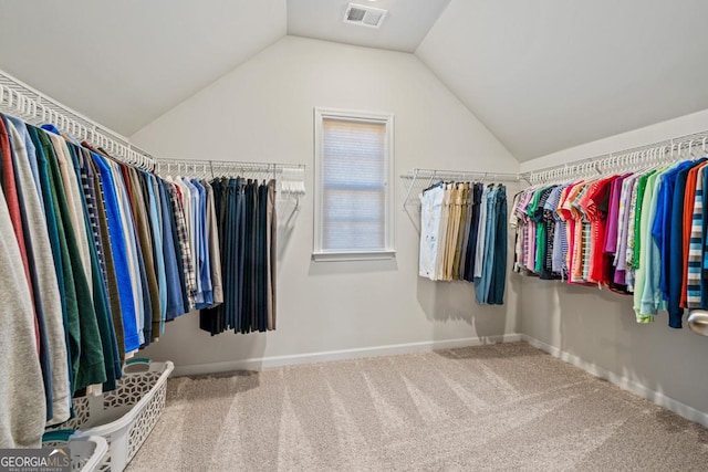 walk in closet featuring carpet floors and vaulted ceiling