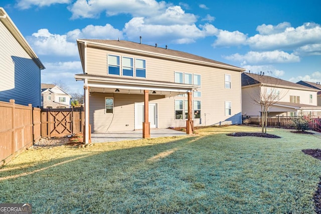 back of house featuring a patio area and a lawn