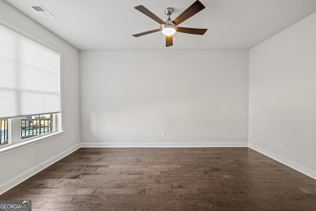 unfurnished room with ceiling fan and dark hardwood / wood-style floors