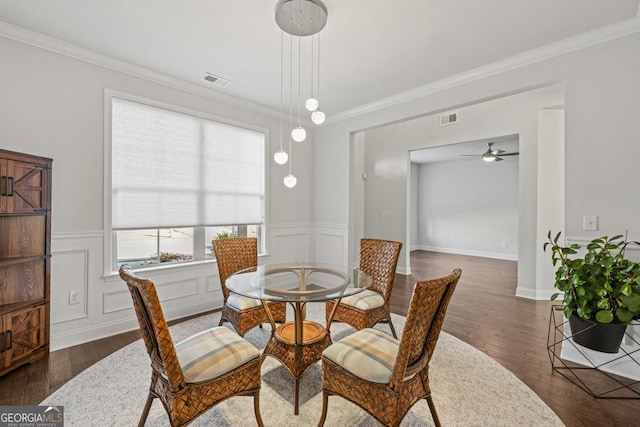 dining room with ceiling fan, ornamental molding, and dark hardwood / wood-style flooring