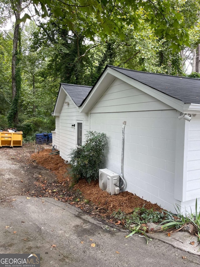 view of side of home with ac unit