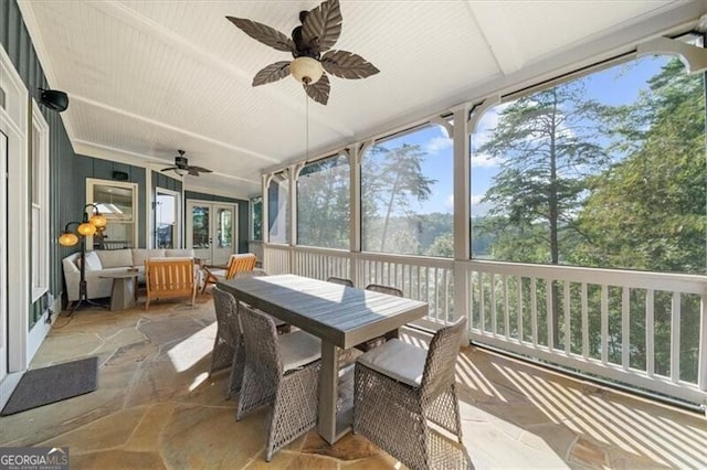 sunroom featuring ceiling fan and vaulted ceiling