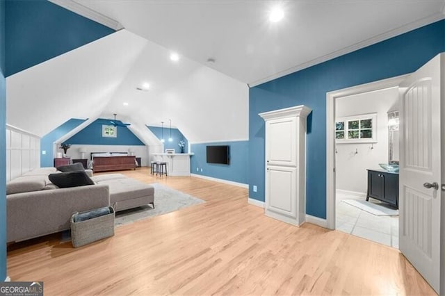 living room featuring lofted ceiling, ceiling fan, ornamental molding, and light hardwood / wood-style flooring