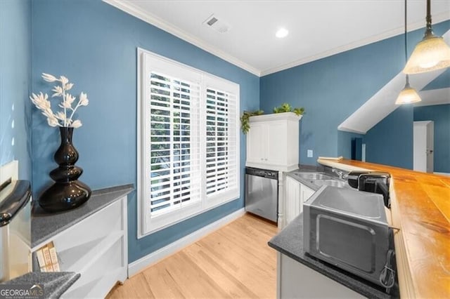 kitchen featuring dishwasher, light hardwood / wood-style floors, hanging light fixtures, butcher block countertops, and white cabinetry