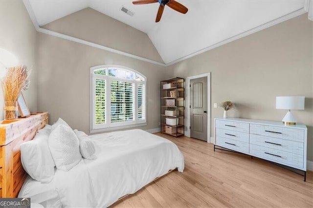 bedroom featuring lofted ceiling, ceiling fan, crown molding, and light hardwood / wood-style floors