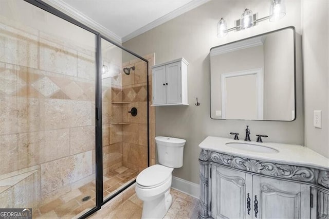 bathroom featuring ornamental molding, toilet, vanity, and a shower with shower door