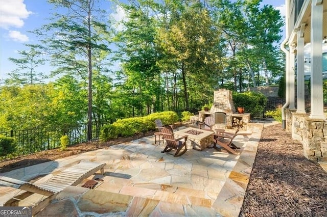 view of patio with an outdoor stone fireplace