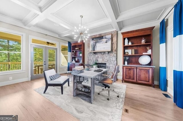 dining area featuring coffered ceiling, french doors, light hardwood / wood-style floors, built in features, and beamed ceiling