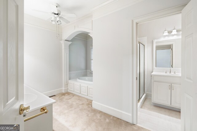 bathroom with ceiling fan, vanity, crown molding, and shower with separate bathtub