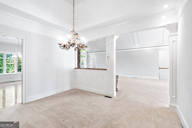 carpeted empty room with a chandelier and crown molding