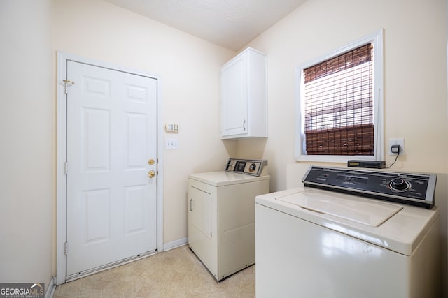 laundry area featuring cabinets and washer and clothes dryer