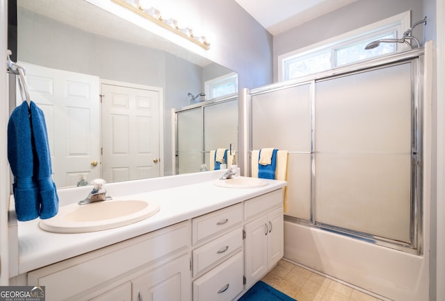 bathroom with enclosed tub / shower combo and vanity