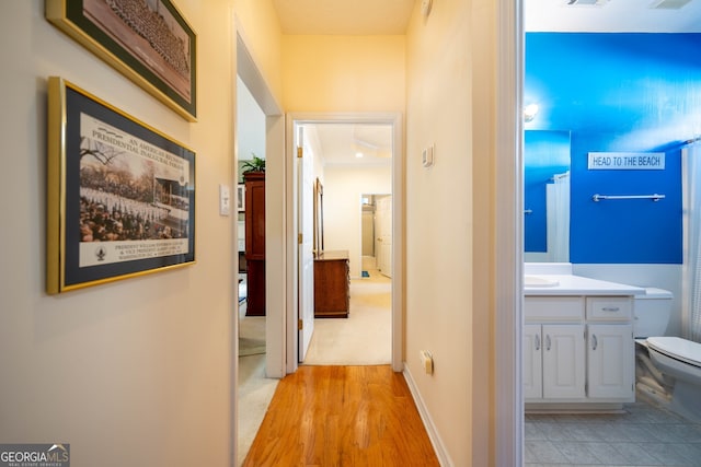 hallway with light wood-type flooring