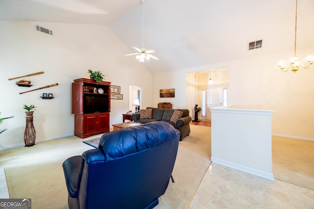 living room with vaulted ceiling, light carpet, and ceiling fan with notable chandelier