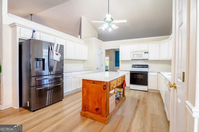 kitchen with stainless steel fridge with ice dispenser, range with electric cooktop, a center island, white cabinetry, and lofted ceiling