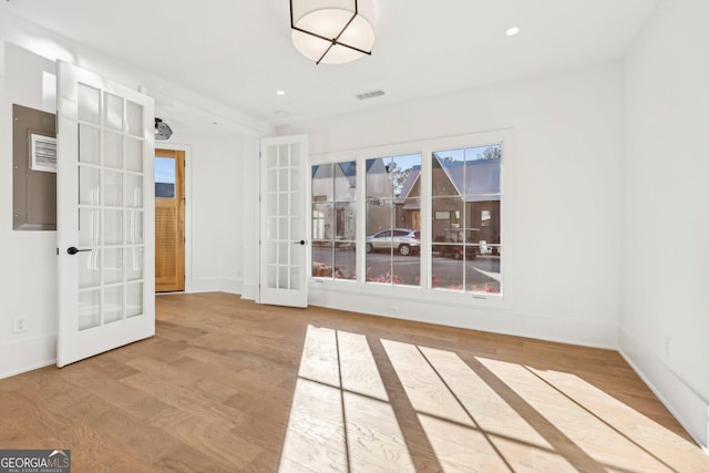 unfurnished room featuring light hardwood / wood-style flooring and french doors