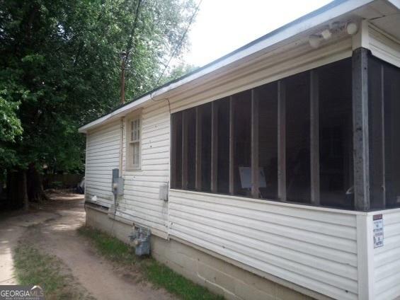 view of side of home with a sunroom