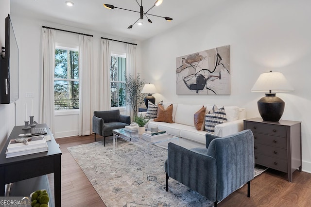 living room featuring a notable chandelier and wood-type flooring