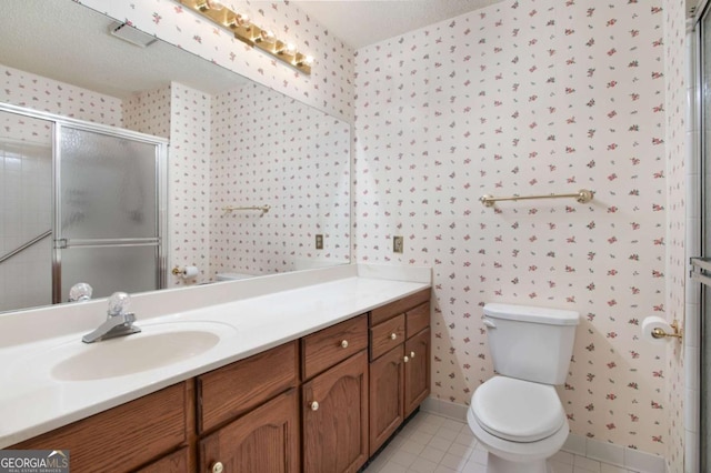 bathroom featuring a shower with door, tile patterned flooring, vanity, and toilet