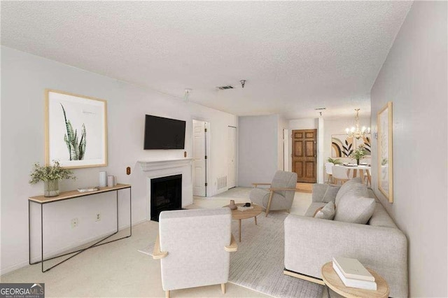 living room featuring a textured ceiling and a notable chandelier