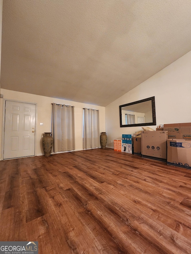 unfurnished living room with a textured ceiling and hardwood / wood-style flooring