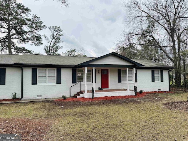 ranch-style house featuring a porch and a front yard