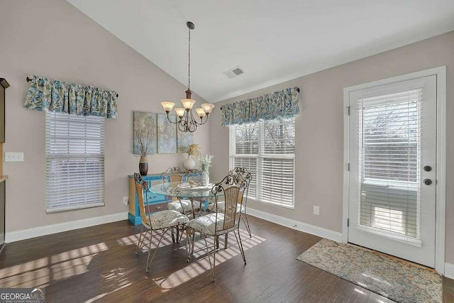 dining space featuring vaulted ceiling, a chandelier, and dark hardwood / wood-style floors