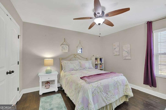 bedroom featuring ceiling fan and dark wood-type flooring