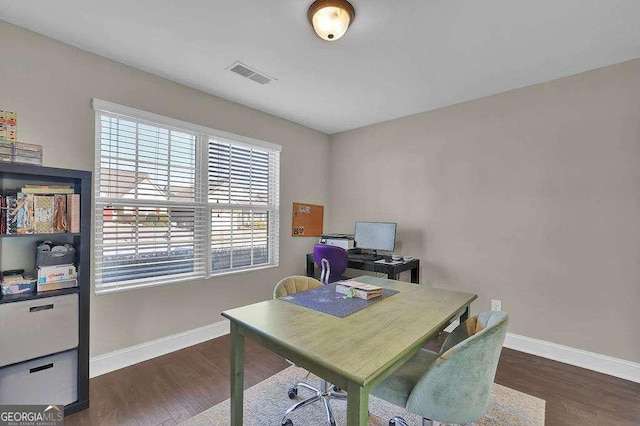 home office with dark hardwood / wood-style flooring